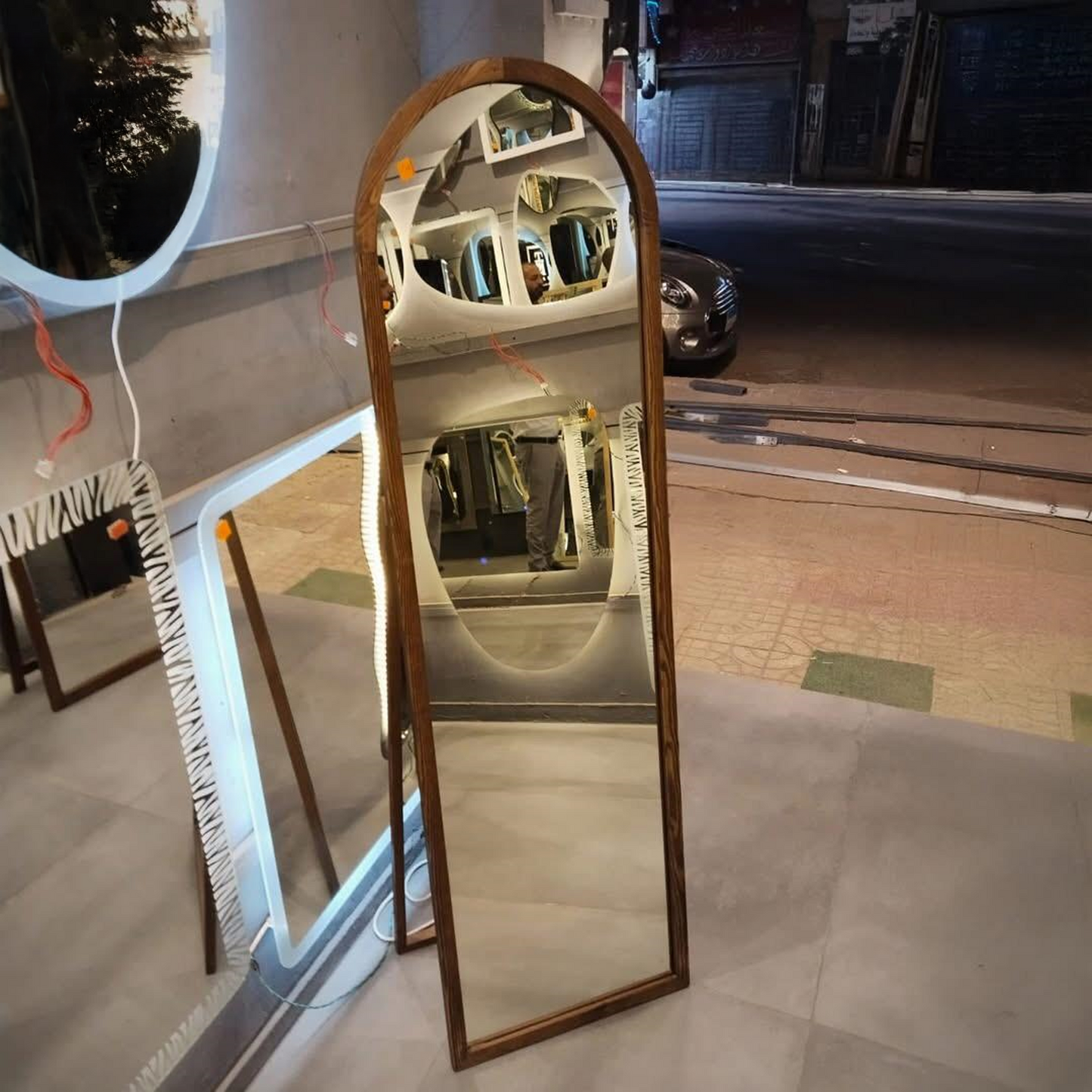 Tall arched mirror with wooden frame